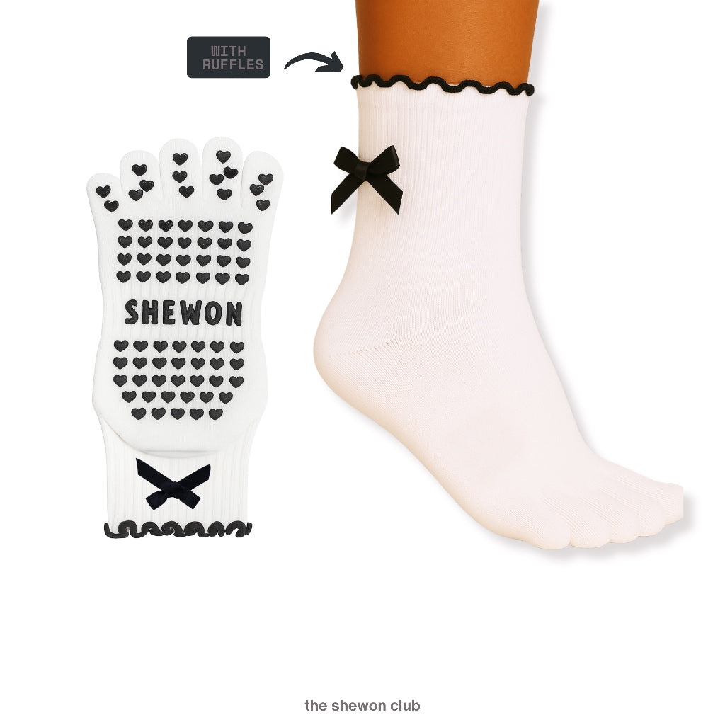 Black and white five-toe Pilates grip socks with bow detail