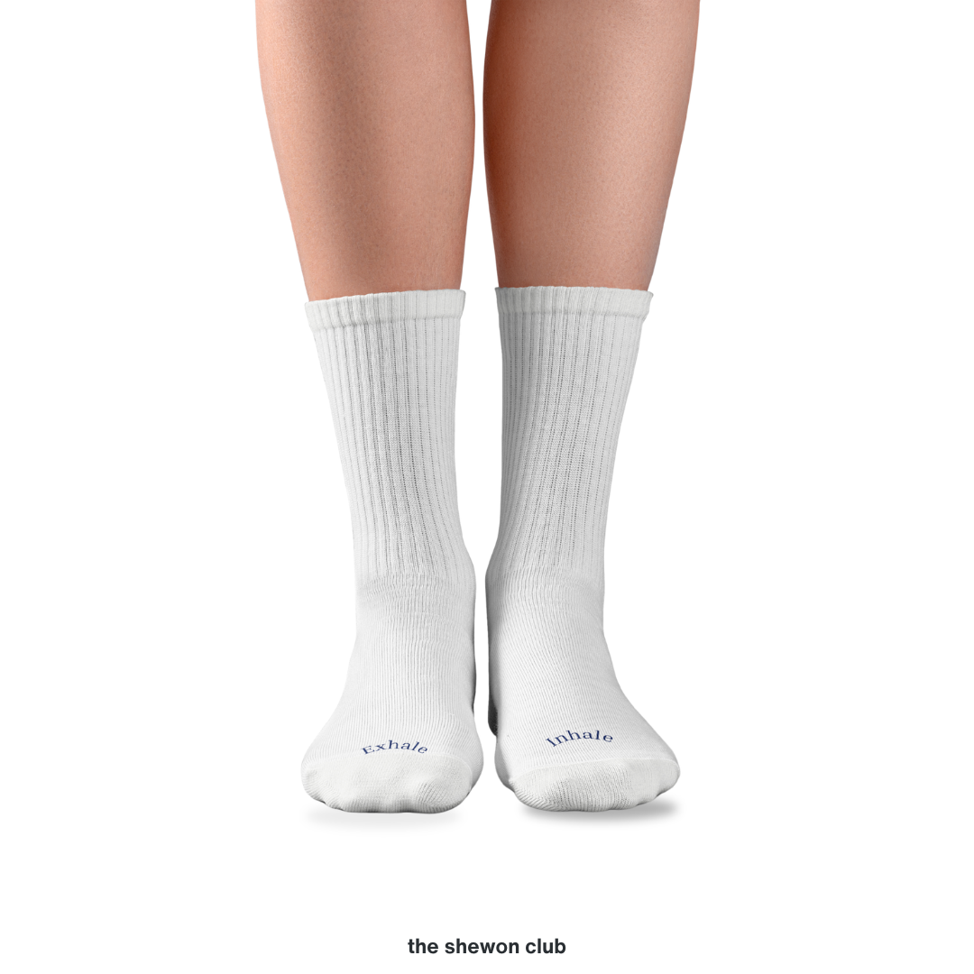 White and navy Pilates crew grip socks with Inhale Exhale lettering