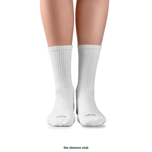 White and navy Pilates crew grip socks with Inhale Exhale lettering