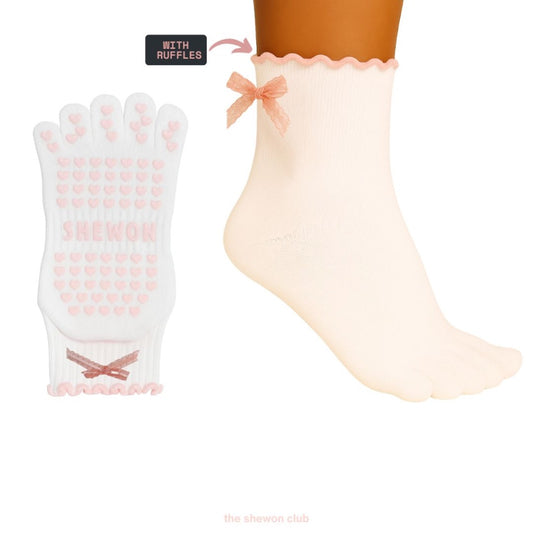Pink and white five-toe Pilates grip socks with lace bow