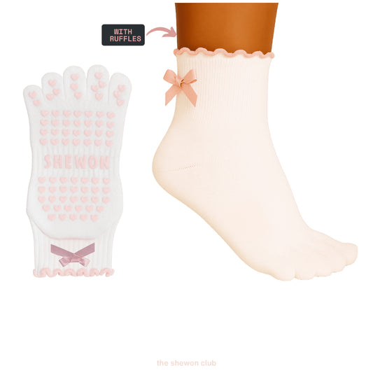 Pink and white five-toe Pilates grip socks with satin bow