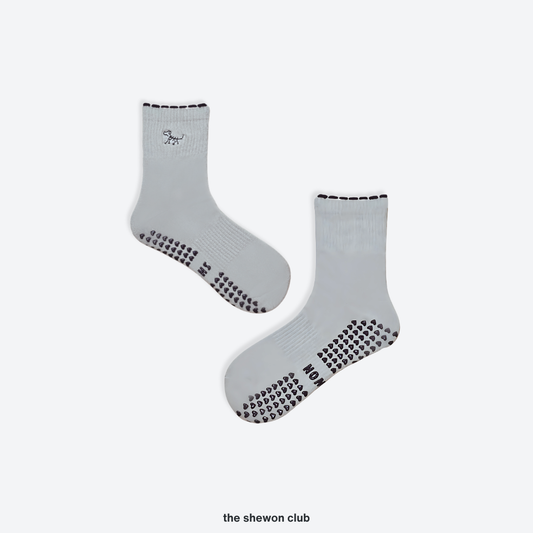 Grey and blue Pilates crew grip socks with embroidered dog design